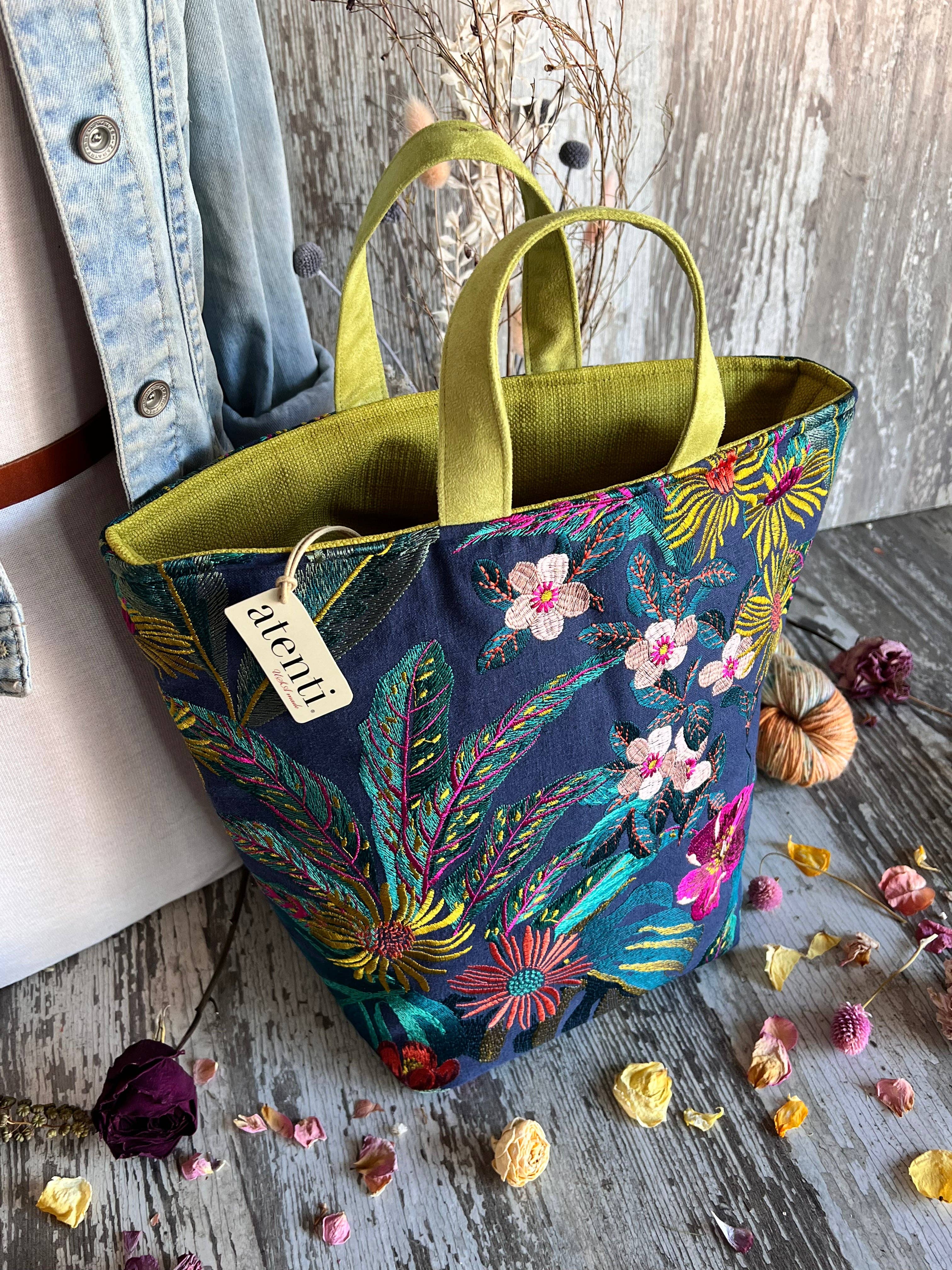 Floral-patterned knitting bag by Atenti Bags with a visible brand tag on a wooden surface.