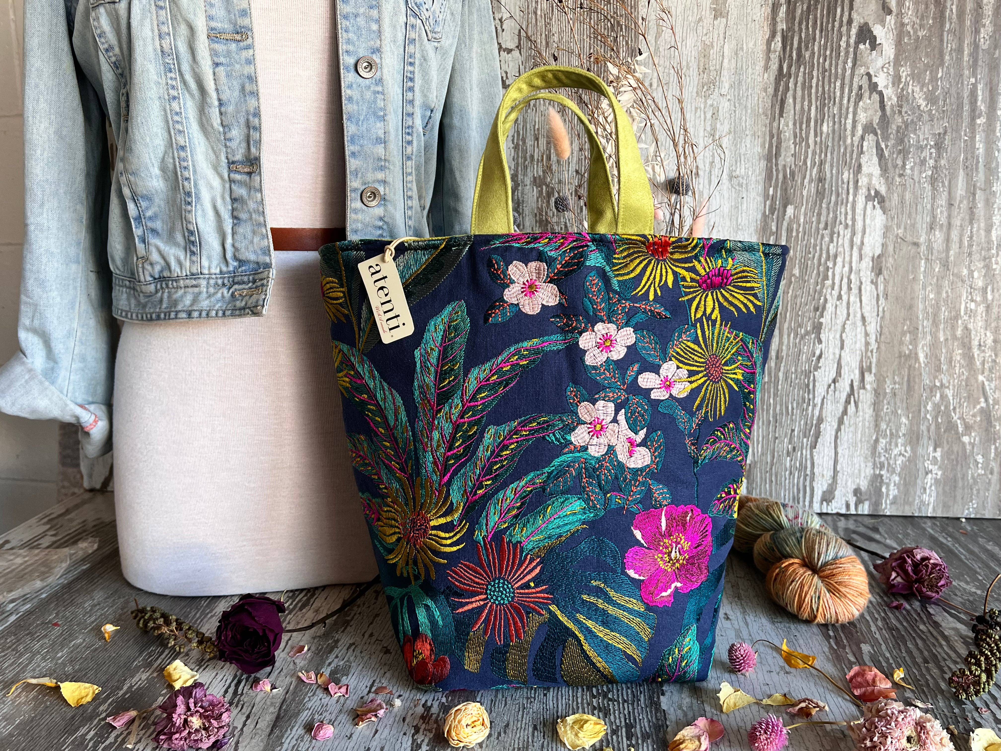 Floral tote bag by Atenti Bags with a denim jacket on a wooden surface