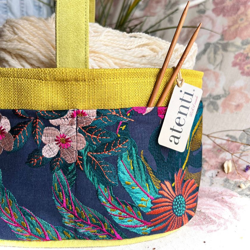 The Flora Caddy by Atenti is colorful embroidered knitting project bag with floral patterns