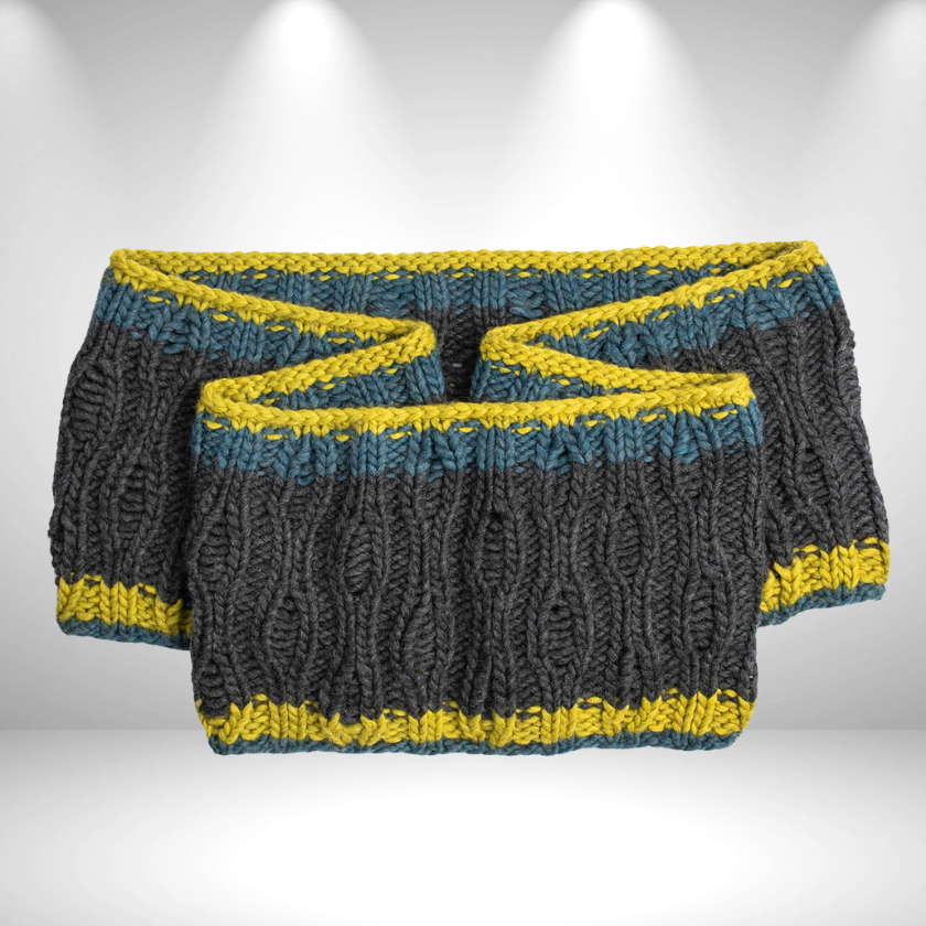 Glacier Cowl laid flat showing bold textured stitch pattern and contrasting colorwork edges in super bulky wool