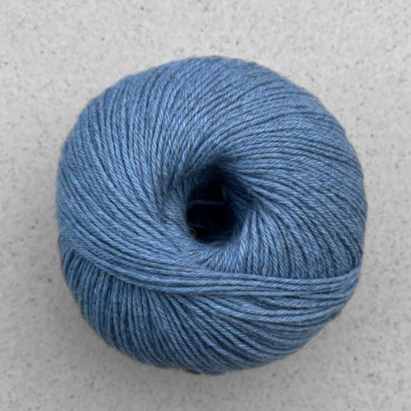 A ball of blue Puno yarn by Pascuali used in the Kiara tee kit from the Dizzy Knitter
