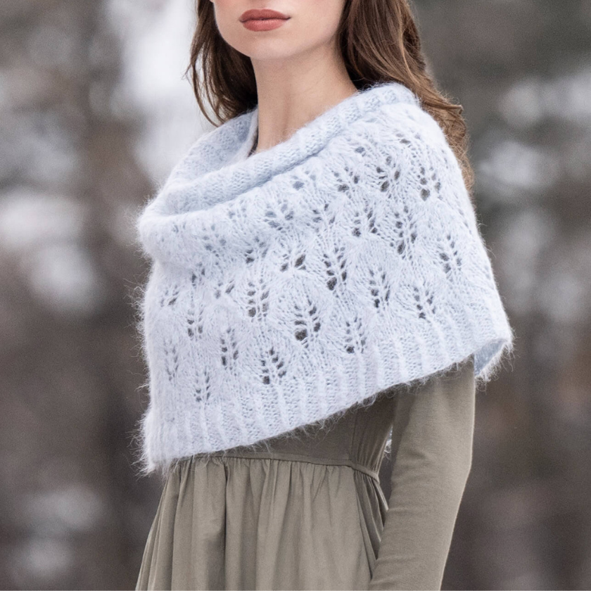 Model wearing the Rime Frost Snood as a lightweight shoulder wrap, showcasing elegant drape and refined lace design — The Dizzy Knitter.