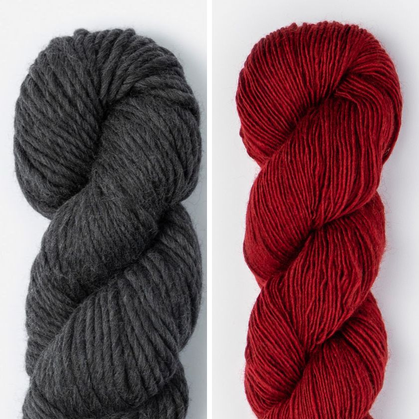 Two skeins of yarn for the Spangle Cowl, one dark grey and one deep red, on a white background.