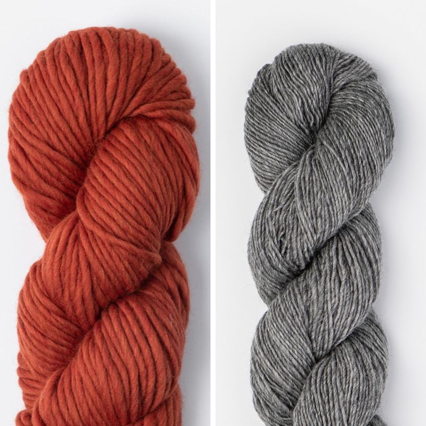 Two skeins of yarn for the Spangle Cowl, one red and one dark gray, on a white background.