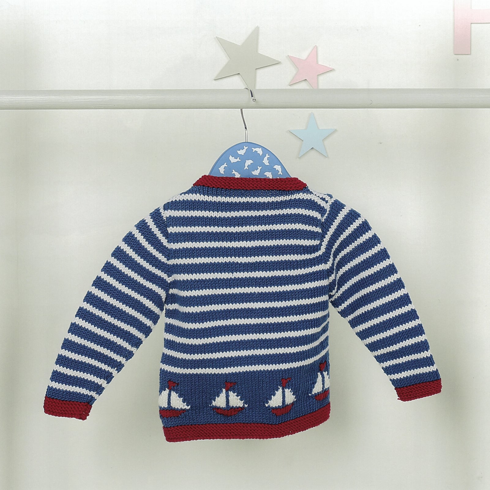 Blue and white striped Bruno baby sweater with sailboat design on a white background